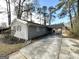 Side view of a gray brick house with a covered carport at 2729 Pinella Sw Dr, Atlanta, GA 30331