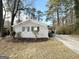 Gray brick house with a carport and mature trees surrounding the property at 2729 Pinella Sw Dr, Atlanta, GA 30331