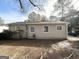 Tan house exterior with small yard and trees at 306 Ard Nw Pl, Atlanta, GA 30331