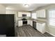 Modern kitchen with white cabinets, granite counters, and stainless steel appliances at 306 Ard Nw Pl, Atlanta, GA 30331