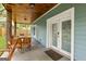 Inviting back porch with a wooden ceiling, comfortable seating, and a view of the backyard at 1302 Ladd St, Atlanta, GA 30310