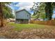 Home featuring a spacious backyard with a patio, wooden fence, and ample space for outdoor enjoyment at 1302 Ladd St, Atlanta, GA 30310