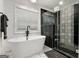 Elegant bathroom with a standalone tub, modern fixtures, patterned tile shower, and bright natural light at 1302 Ladd St, Atlanta, GA 30310