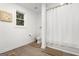 Clean bathroom featuring a toilet, shower with curtain and tiled floor at 1302 Ladd St, Atlanta, GA 30310