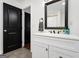 Bathroom with black door, white vanity, and tile flooring at 1302 Ladd St, Atlanta, GA 30310