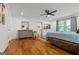 Spacious bedroom with hardwood floors, grey dresser, and a ceiling fan at 1302 Ladd St, Atlanta, GA 30310