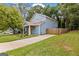 Charming blue home featuring a well-maintained lawn and long driveway at 1302 Ladd St, Atlanta, GA 30310