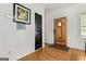 Welcoming foyer featuring wood-look floors and a striking wood front door with sidelight at 1302 Ladd St, Atlanta, GA 30310