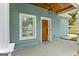 Inviting blue house exterior featuring a light wood front door with a charming lantern fixture at 1302 Ladd St, Atlanta, GA 30310