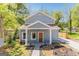 Charming blue two-story home featuring a landscaped yard and a welcoming front porch at 1302 Ladd St, Atlanta, GA 30310