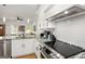 Bright kitchen boasts granite counters, stainless appliances, white cabinets and an open-concept layout with barstool seating at 1302 Ladd St, Atlanta, GA 30310