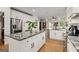 Bright kitchen featuring stainless steel appliances, granite counters, an island with bar seating, and white cabinets at 1302 Ladd St, Atlanta, GA 30310