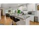 Bright kitchen boasts granite counters, stainless appliances, island with bar seating, and an open-concept floorplan at 1302 Ladd St, Atlanta, GA 30310