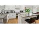 Bright kitchen features granite counters, subway tile backsplash, stainless appliances, and an island with bar seating at 1302 Ladd St, Atlanta, GA 30310