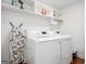 Well-organized laundry room with modern washer and dryer, storage shelves and ironing board at 1302 Ladd St, Atlanta, GA 30310
