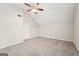 Bright bedroom with grey carpet, ceiling fan, and door to closet at 9507 Byrom Rd, Jonesboro, GA 30236