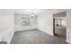 Elegant dining room, gray tile floors, wainscoting, chandelier at 9507 Byrom Rd, Jonesboro, GA 30236