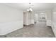 Sunlit dining room, gray tile floors and wainscoting detail at 9507 Byrom Rd, Jonesboro, GA 30236