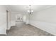 Open concept dining room with gray tile floors and wainscoting at 9507 Byrom Rd, Jonesboro, GA 30236