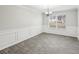 Dining room with gray tile floors, wainscoting and chandelier at 9507 Byrom Rd, Jonesboro, GA 30236