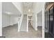 Bright entryway with tile flooring, staircase, and view to kitchen at 9507 Byrom Rd, Jonesboro, GA 30236