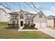Two story brick home with attached two-car garage and landscaped lawn at 9507 Byrom Rd, Jonesboro, GA 30236