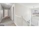 Upstairs hallway with carpet and view of staircase at 9507 Byrom Rd, Jonesboro, GA 30236