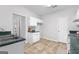 Kitchen with white cabinets, green countertops, and view of hallway at 25 Chemin Pl, Sharpsburg, GA 30277