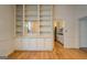 White built-in shelving with cabinets and a view of the kitchen at 960 Todd Dr, Covington, GA 30014