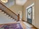 Two-story entryway with hardwood floors, wooden staircase, and a view of the living room at 960 Todd Dr, Covington, GA 30014