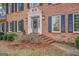 Brick front entry with gray door and detailed trim at 960 Todd Dr, Covington, GA 30014