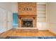 Brick fireplace with a wood mantel and built-in shelving at 960 Todd Dr, Covington, GA 30014