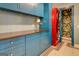 Laundry room with blue cabinets and red stacked washer/dryer at 960 Todd Dr, Covington, GA 30014