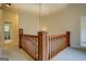 Upper hallway with wood railing and carpeting, includes access to bathroom at 960 Todd Dr, Covington, GA 30014