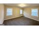 Bright bedroom with three windows and neutral carpeting at 2780 Mitchell Dr, Decatur, GA 30032