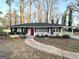 Brick ranch home with red door and mature trees at 2780 Mitchell Dr, Decatur, GA 30032
