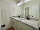 Bathroom featuring granite countertop, white cabinets with black hardware, and a walk-in shower at 4619 Parkwood Rd, Social Circle, GA 30025