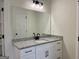 Bright bathroom with white cabinets, black hardware and fixtures, and neutral toned granite countertop at 4619 Parkwood Rd, Social Circle, GA 30025