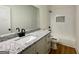 Clean bathroom with white vanity, granite countertops, and a shower-tub combination at 4619 Parkwood Rd, Social Circle, GA 30025