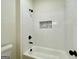 Modern bathroom features a tiled shower and bathtub with black fixtures and a stylish inset at 4619 Parkwood Rd, Social Circle, GA 30025