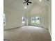 Large bedroom with neutral carpeting, vaulted ceiling, and plenty of natural light at 4619 Parkwood Rd, Social Circle, GA 30025