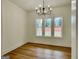Elegant dining room with modern chandelier lighting and a view of the outdoors through large windows at 4619 Parkwood Rd, Social Circle, GA 30025
