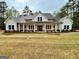 Inviting two-story modern farmhouse with a welcoming front porch and a well-manicured lawn at 4619 Parkwood Rd, Social Circle, GA 30025
