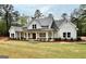 Charming home with a covered front porch, showcasing a blend of modern design and country charm at 4619 Parkwood Rd, Social Circle, GA 30025