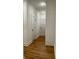 Hallway with wood floors and white paneled doors, leading to various rooms in the home at 4619 Parkwood Rd, Social Circle, GA 30025