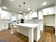 Bright, spacious kitchen features white cabinets, a large island, and stainless steel appliances at 4619 Parkwood Rd, Social Circle, GA 30025