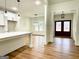 Open-concept kitchen and dining area with modern pendant lighting and hardwood floors at 4619 Parkwood Rd, Social Circle, GA 30025