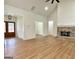 Spacious living room featuring a brick fireplace, high ceilings, and hardwood flooring at 4619 Parkwood Rd, Social Circle, GA 30025