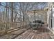 Inviting deck with outdoor dining set and grill, backing onto a forest at 230 Hedgewick Way, Tyrone, GA 30290