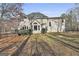 Back exterior featuring a large lawn, deck, and large windows at 230 Hedgewick Way, Tyrone, GA 30290